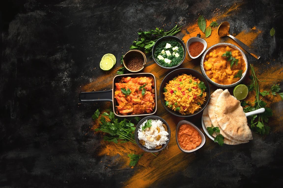 A spread of curries, rice and bread to share